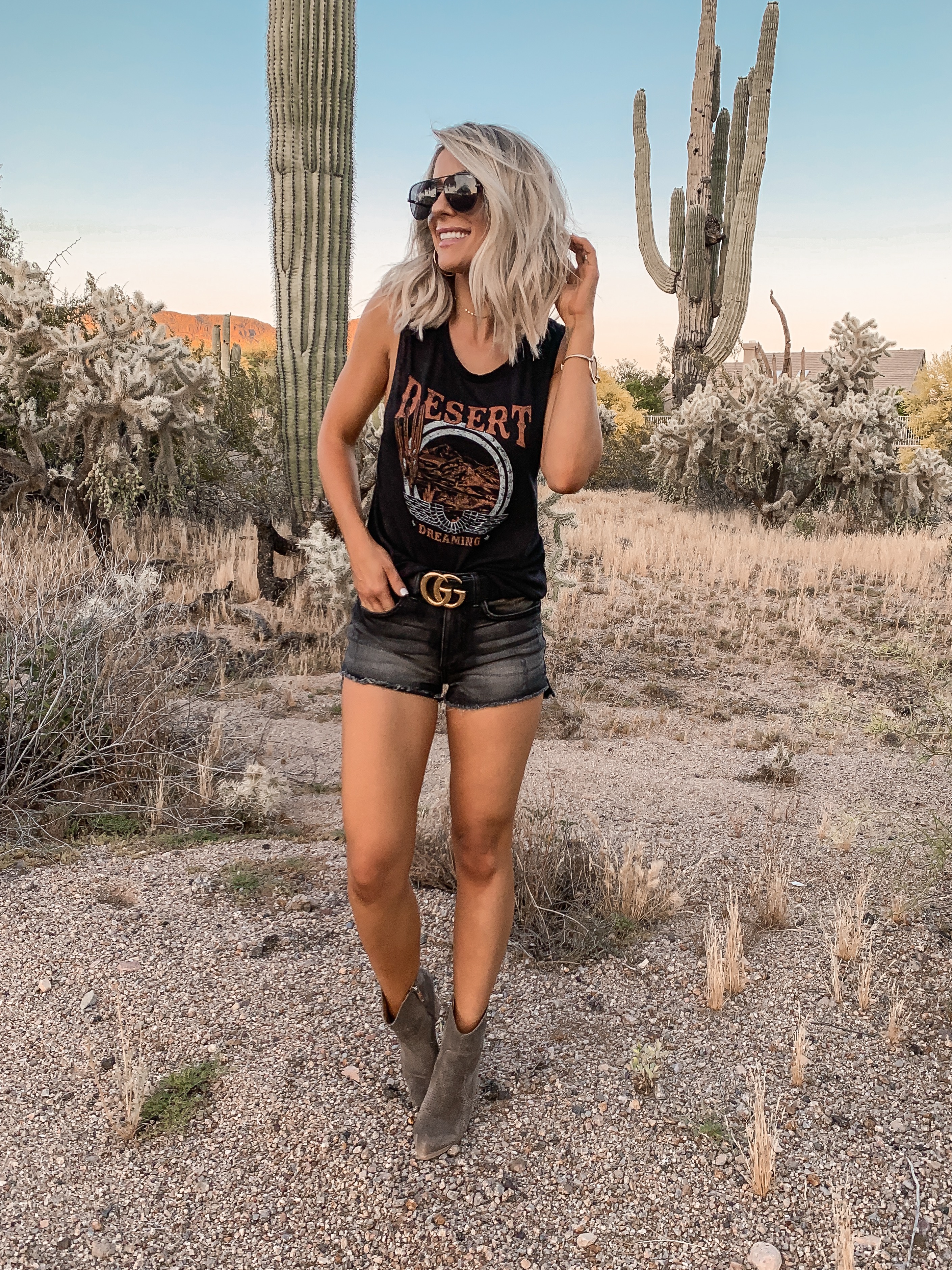Coachella Stagecoach Festival concert outfit idea black desert outfit black gucci belt Laura Beverlin Short blonde Hair