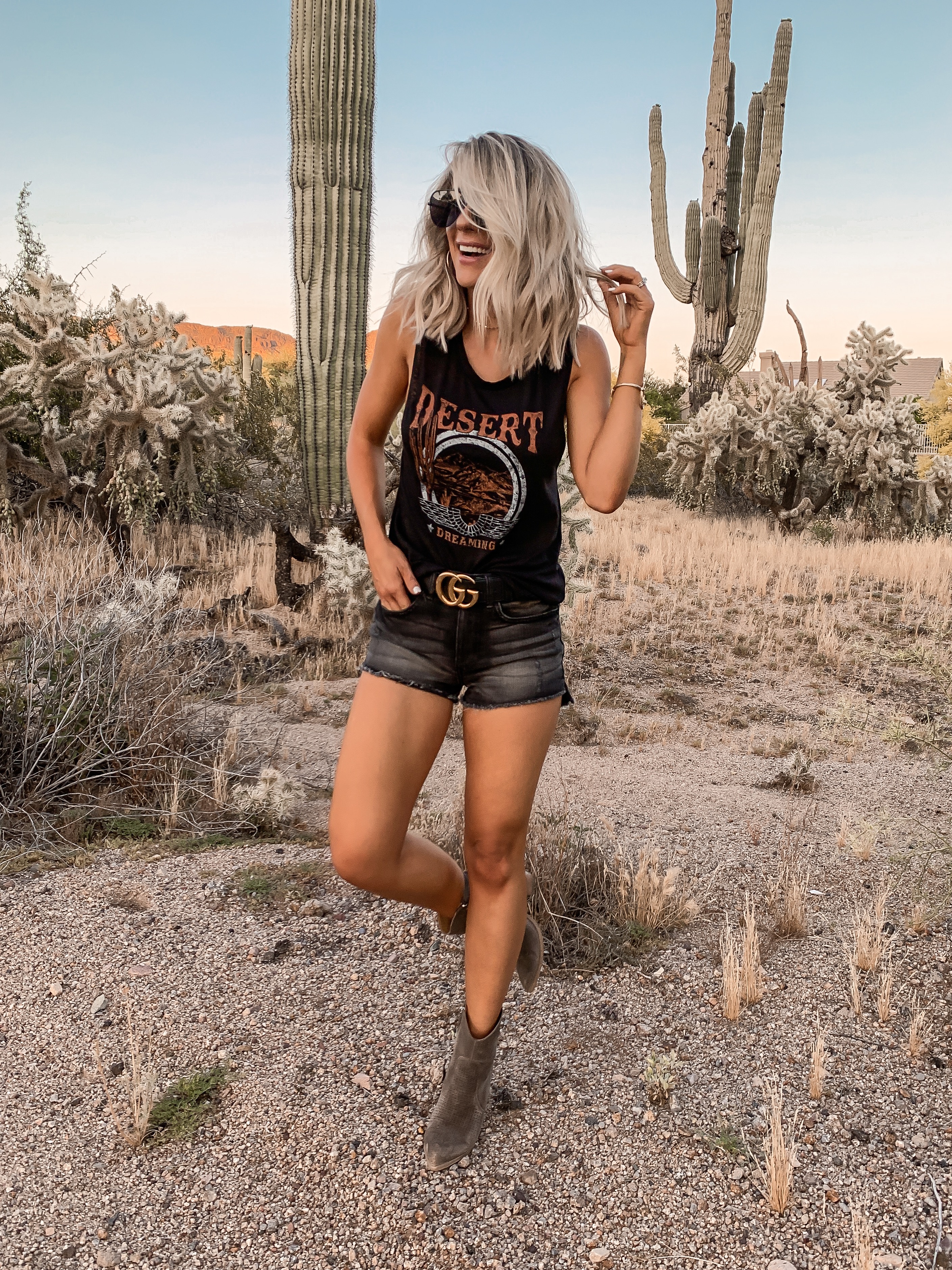 Coachella Stagecoach Festival concert outfit idea black desert outfit black gucci belt Laura Beverlin Short blonde Hair